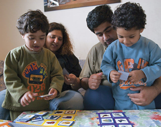 Young Family Playing a Card Game