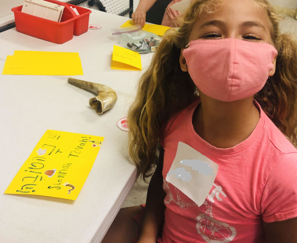 Girl with mask in a Hebrew language class.